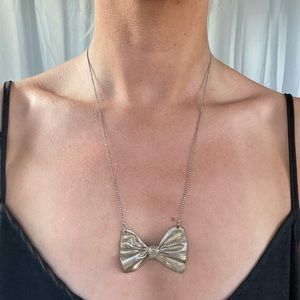 Gold brushed bow tie necklace